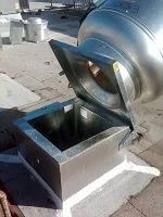 Kitchen exhaust fan hinged up for cleaning access